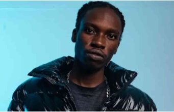 Rapper Toxic Lyrikali Claims He Was Coerced to Chant ‘Tutam’ Toxic Lyrical shouts “two term” for President Ruto during State House event. The video shows him hesitating before making the chant. Social media divided—some call it pressure, others accuse him of selling out. Event was part of a youth empowerment program in Nairobi. State House Performance Turns Political A performance by Kenyan rapper Toxic Lyrical at State House has stirred heated reactions online. The artist, famous for his energetic street hits, found himself in the spotlight after publicly chanting “two term” in support of President William Ruto’s presidency. The incident happened during a presidential youth empowerment event in Nairobi, where over 1,100 packages — including motorbikes and car wash equipment — were handed to youth groups. How the Chant Happened In a now viral clip, Dagoretti South MP John Kiarie invites Toxic to address the crowd. The rapper pauses briefly, then shouts “tutam” (slang for two term), sparking loud cheers. President Ruto responded with a handshake. Later, Toxic posted on social media, writing in a playful yet telling tone: “Ground ni ile ile. Niseme one tam akiwa apo nipotezwe?” (Should I say one term while he’s standing there and risk disappearing?) Fans Split Over His Actions The shout has sharply divided fans. Supporters believe he acted under pressure, pointing to the visible tension before he spoke. Critics, however, unfollowed him and accused him of abandoning the struggles of jobless youth, victims of police abuse, and those battling economic hardship. Politics and Music in the Spotlight This moment adds to a growing list of cases where Kenyan entertainers are judged for their political stand. Many fans now question whether musicians can remain neutral when performing for political leader