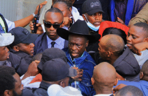 Gachagua attempted to escape arrest amid clashes between DCI officers and his supporters, reports Despite the commotion, Gachagua eventually made it to his vehicle and popped out of the sunroof to wave at the ecstatic crowds. The return of President William Ruto’s fiercest critic comes after a 43-day tour of the U.S., where he held engagements with the Kenyan diaspora while popularizing his new political vehicle, the Democratic Change Party (DCP). His homecoming had been highly publicized, with many linking it to the upcoming by-elections in which DCP has fielded candidates. DCP deputy party leader Cleophas Malala had earlier urged supporters to flock to JKIA, framing the reception as more than a mere welcome. “This is not just a welcome—it is a statement to the world that Kenya belongs to her people,” Malala declared, while warning the government against any attempt to arrest Gachagua upon arrival. The calls drew a sharp response from the State. Speaking in Murang’a during the Jukwaa la Usalama forum, Interior Cabinet Secretary, flanked by Inspector General of Police Douglas Kanja, dismissed the hype around Gachagua’s landing. “There are so many people landing in Kenya every day, so I don’t know why we should be worried when one person is landing,” the CS remarked. He, however, warned Gachagua and his allies against fanning tensions through inflammatory remarks. “For the time he has been away, the country has been relatively peaceful,” the CS said, assuring that security agencies are on standby to deal with any disruptions. Gachagua’s return is set to test the delicate balance between his growing political movement and the government’s resolve to contain dissent ahead of looming electoral contests.