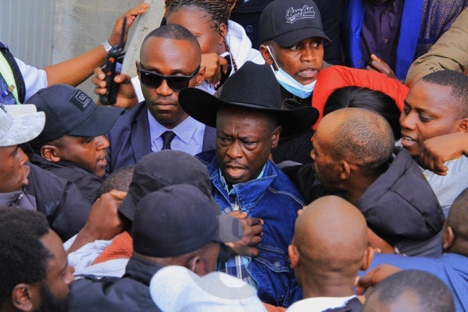 Gachagua attempted to escape arrest amid clashes between DCI officers and his supporters, reports Despite the commotion, Gachagua eventually made it to his vehicle and popped out of the sunroof to wave at the ecstatic crowds. The return of President William Ruto’s fiercest critic comes after a 43-day tour of the U.S., where he held engagements with the Kenyan diaspora while popularizing his new political vehicle, the Democratic Change Party (DCP). His homecoming had been highly publicized, with many linking it to the upcoming by-elections in which DCP has fielded candidates. DCP deputy party leader Cleophas Malala had earlier urged supporters to flock to JKIA, framing the reception as more than a mere welcome. “This is not just a welcome—it is a statement to the world that Kenya belongs to her people,” Malala declared, while warning the government against any attempt to arrest Gachagua upon arrival. The calls drew a sharp response from the State. Speaking in Murang’a during the Jukwaa la Usalama forum, Interior Cabinet Secretary, flanked by Inspector General of Police Douglas Kanja, dismissed the hype around Gachagua’s landing. “There are so many people landing in Kenya every day, so I don’t know why we should be worried when one person is landing,” the CS remarked. He, however, warned Gachagua and his allies against fanning tensions through inflammatory remarks. “For the time he has been away, the country has been relatively peaceful,” the CS said, assuring that security agencies are on standby to deal with any disruptions. Gachagua’s return is set to test the delicate balance between his growing political movement and the government’s resolve to contain dissent ahead of looming electoral contests.